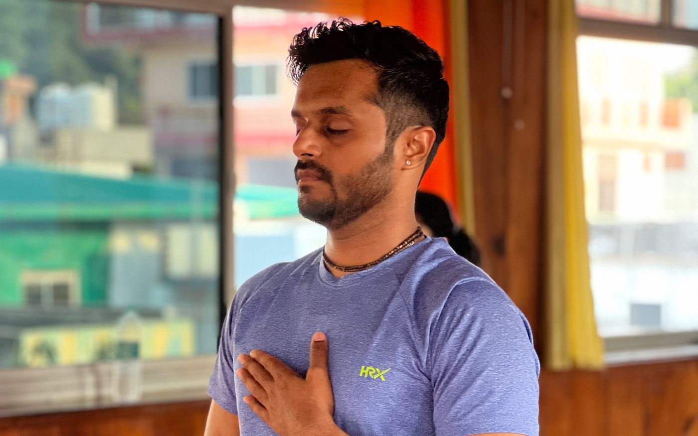 Prathamesh Chavan practising diaphragmatic breathing with one hand on the chest